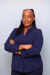 Ellis  Orthodontics  Receptionist,  Sigonee  in  navy  scrubs  with  arms  crossed